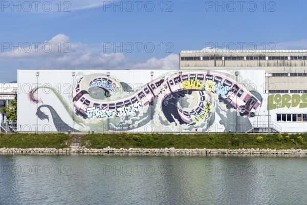 Large-scale dynamic graffiti depiction of a winding train, at the harbour in Linz, Upper Austria Austria