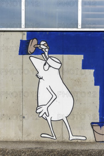 Cartoon painter painting an abstract blue surface on a concrete wall at the harbour of Linz Upper Austria Austria