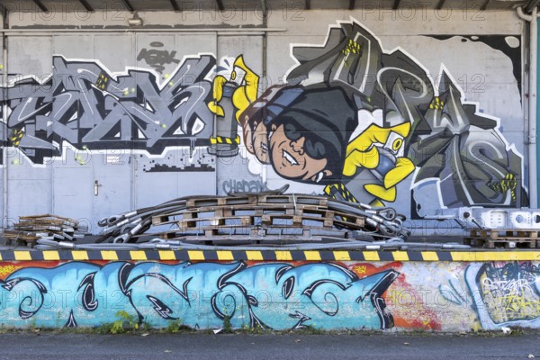 Humorous graffiti with a man and colourful lettering, at the port of Linz Upper Austria Austria