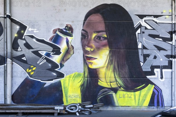 Realistic portrait of a woman with spray cans in her hand, at the harbour Linz Upper Austria Austria