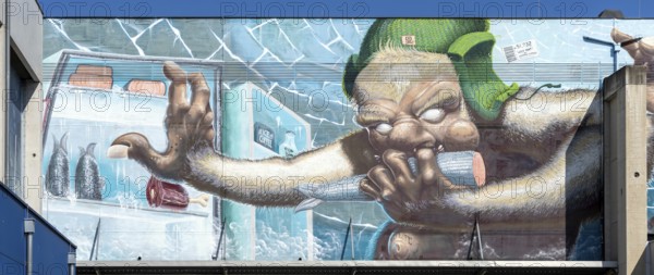Caricature of a monster searching a fridge, as graffiti, at the harbour of Linz Upper Austria Austria