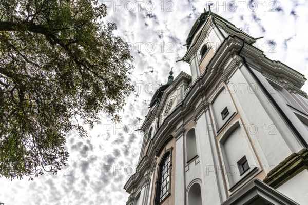 Impressive view of a baroque church from below with silhouette of trees, Pöstlingsbergkirche pilgrimage basilica Sieben Schmerzen Maria Linz Upper Austria Austria