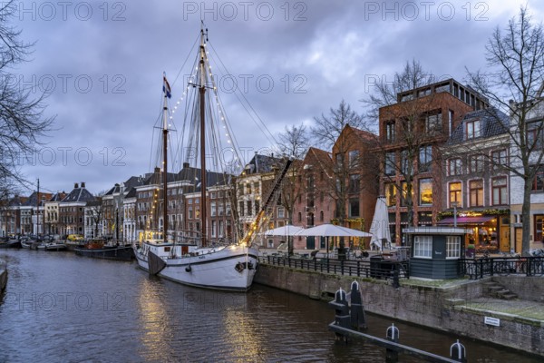 Typical canal with sailing boats in Groningen at dusk, Netherlands