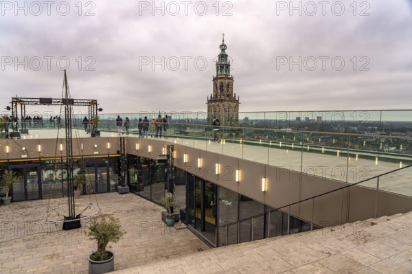 Roof terrace of the Forum Groningen and the Martinitoren church tower of the Martinikerk or Martini church in Groningen, Netherlands