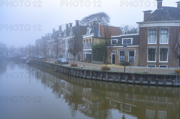 Typical canal in the winter fog, Harlingen, Friesland, Netherlands