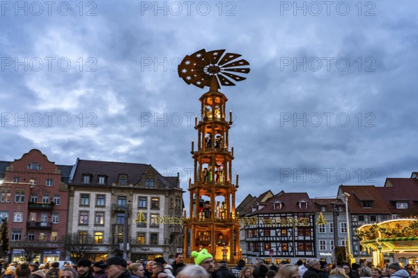 Christmas pyramid at the Christmas market on the cathedral square in the old town centre of Erfurt at dusk, Thuringia, Germany