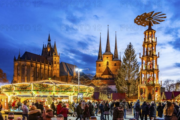 Christmas market with Christmas pyramid in front of Erfurt Cathedral and the Church of St Severus on Cathedral Square in the old town centre of Erfurt at dusk, Thuringia, Germany