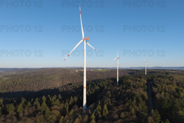 A wind farm with several turbines on a hill surrounded by forests, near Schorndorf in the Rems Valley, Baden-Württemberg, Germany