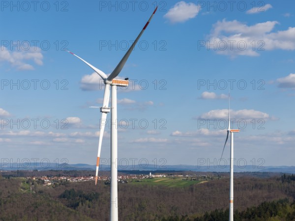 Close-up of wind turbines with a village in the background, maintenance work, repair, near Schorndorf im Remstal, Baden-Württemberg, Germany