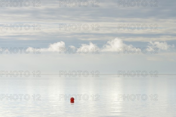 North Sea coast, special light atmosphere over the Wadden Sea with rising water and calm wind, red buoy, Norddeich, Lower Saxony, Germany