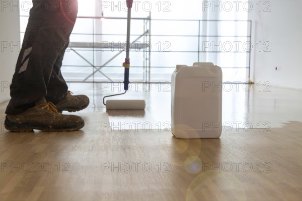 Professional sealing of a new parquet floor with lacquer