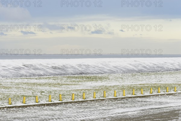 North Sea coast on a winter's day, snow-covered dyke and boundary posts, North Sea, Norddeich, Lower Saxony, Germany