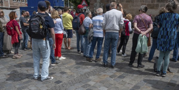 Interested tourists listen to a music group in the pedestrian zone, Nuremberg, Middle Franconia, Bavaria, Germany