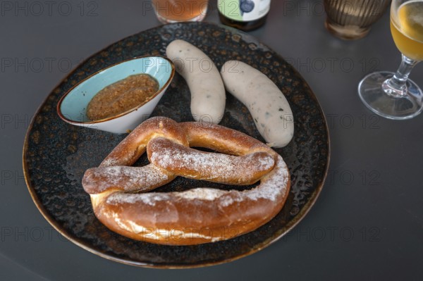 Plate with white sausages, sweet mustard and a pretzel, Franconia, Bavaria, Germany