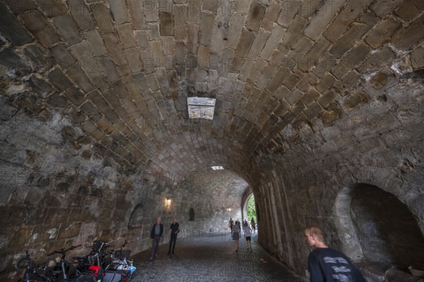 Tourists walk through the historic entrance to the Imperial Castle, Nuremberg, Middle Franconia, Bavaria, Germany
