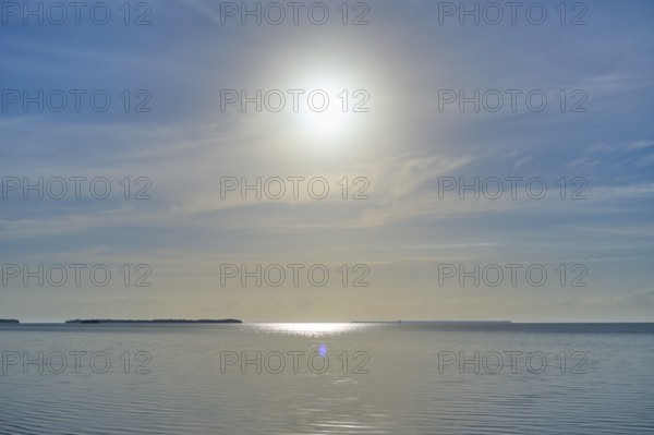 The sun shines over a calm sea under a blue sky, Flamingo, Everglades National Park, Florida, USA