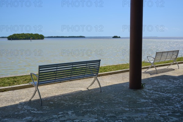 Two benches with a view of the sea and distant islands against a clear sky, Flamingo, Everglades National Park, Florida, USA