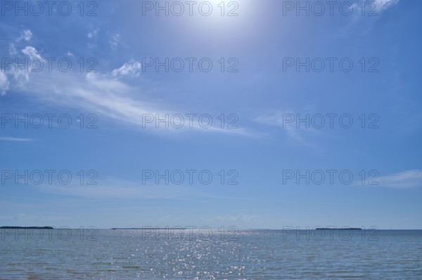 Sparkling water under a clear blue sky with the sun high above, Flamingo, Everglades National Park, Florida, USA