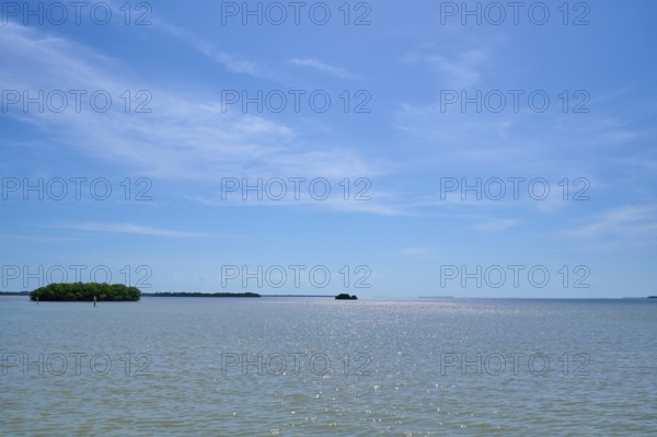 Islands on a calm sea under a light blue sky with light clouds, Flamingo, Everglades National Park, Florida, USA