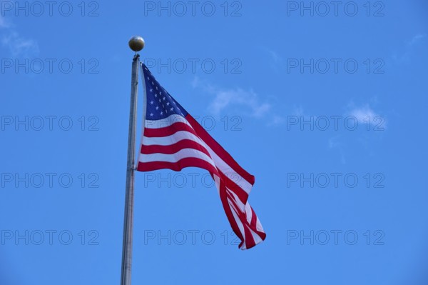 American flag waving against the clear, cloudy sky, Flamingo, Everglades National Park, Florida, USA