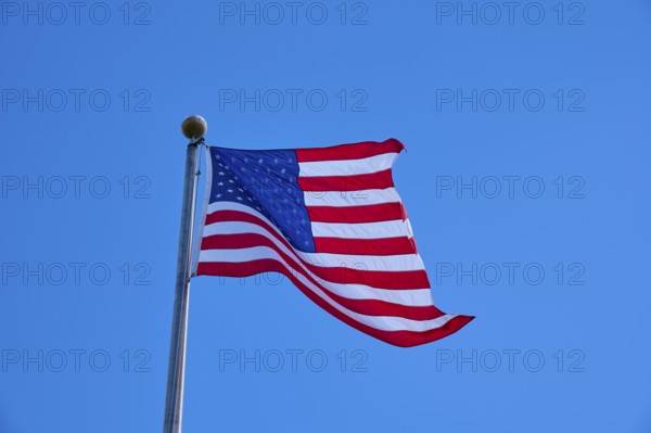 American flag flies majestically in front of a slightly cloudy sky, Flamingo, Everglades National Park, Florida, USA