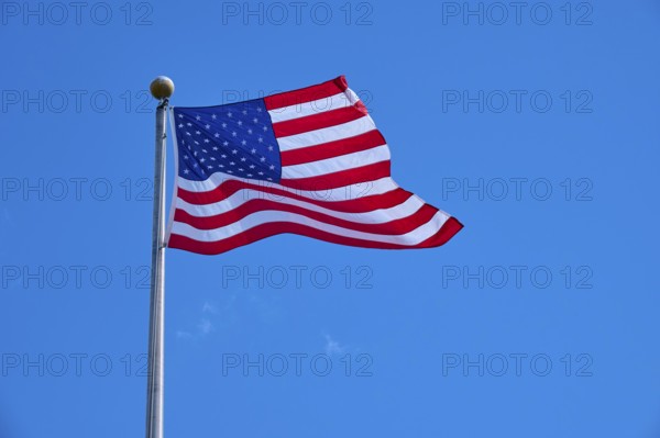Stars and Stripes waving on a pole under a clear sky, Flamingo, Everglades National Park, Florida, USA