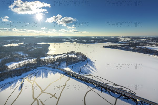 Aerial view, Möhnesee and Delecker Brücke, Delecke, Möhnesee, Sauerland, North Rhine-Westphalia, Germany, Arnsberger Straße, bridge, DE, Europe, distant view, backlight, aerial view, aerial photography, aerial photography, cracks in the ice, snow, sun, overview, bird's eye view, winter at Möhnesee, winter landscape, birds-eyes view, blue sky, overview