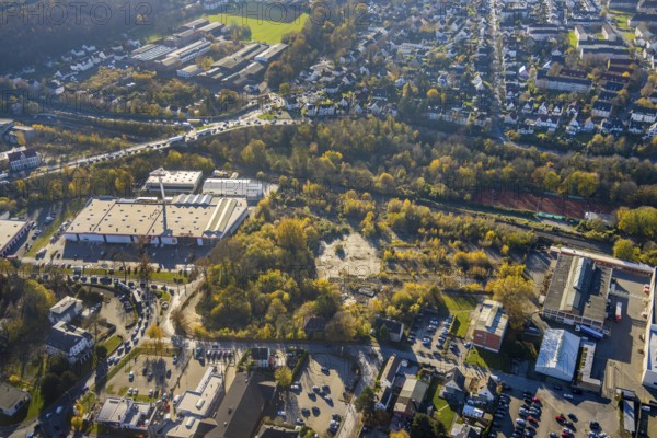 Aerial view, brownfield site on Carl-Benz-Straße between Hellweg Baumarkt and HME Copper Germany in Menden, Sauerland, North Rhine-Westphalia, Germany, construction area, construction site, building plots, DE, Europe, commercial enterprises, commercial area, commercial park, commercial site, commercial use, industrial area, industrial building, industrial site, aerial view, aerial photography, aerial photography, Menden, overview, bird's-eye view, overview