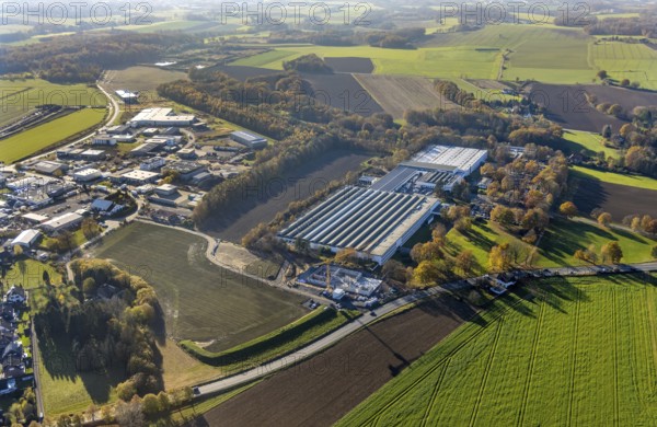 Aerial view, Bega Gantenbrink-Leuchten company premises with construction site in the Halingen district of Menden, Sauerland, North Rhine-Westphalia, Germany, construction work, construction area, building site, building plots, construction project, construction site, DE, Europe, commercial enterprises, commercial area, commercial park, commercial location, commercial use, industrial area, industrial building, industrial location, aerial photograph, aerial photography, aerial photography, Menden, new building, overview, bird's eye view, bird's eye view, overview