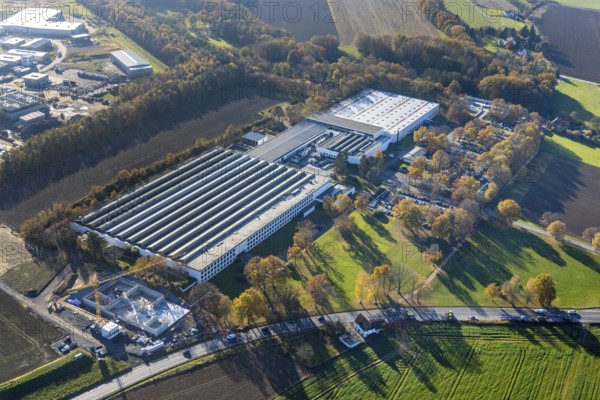 Aerial view, Bega Gantenbrink-Leuchten company premises with construction site in the Halingen district of Menden, Sauerland, North Rhine-Westphalia, Germany, construction work, construction area, building site, building plots, construction project, construction site, DE, Europe, commercial enterprises, commercial area, commercial park, commercial location, commercial use, industrial area, industrial building, industrial location, aerial photograph, aerial photography, aerial photography, Menden, new building, overview, bird's eye view, bird's eye view, overview