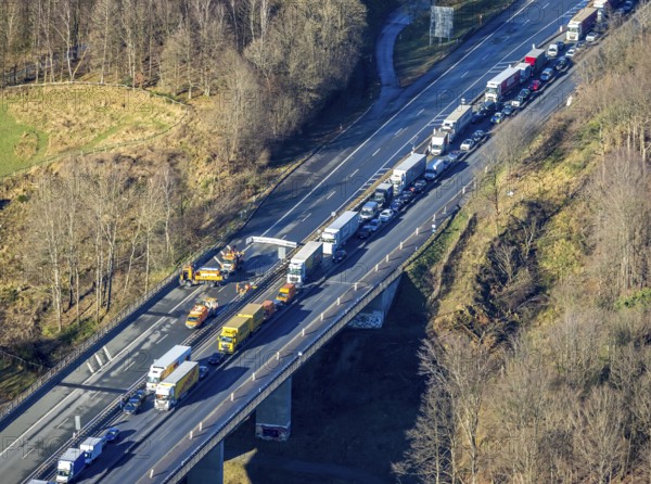 Aerial view, truck traffic jam on the Sterbecke viaduct in front of the closed Rahmede viaduct of the A45 Sauerlandlinie motorway in the Heedfeld district of Schalksmühle, Sauerland, North Rhine-Westphalia, Germany, A45, DE, Europe, truck traffic jam, aerial view, aerial photography, aerial photography, through road, Sauerlandlinie, Schalksmühle, damage to the steel structure, closure of the Rahmede viaduct, traffic jam, traffic jam, overview, traffic volume, traffic chaos, traffic infrastructure, traffic jam, bird's eye view, bird's eye view, lack of load-bearing capacity, closed Rahmede viaduct, dilapidated bridge, dilapidated bridges, overview