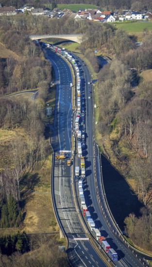 Aerial view, truck traffic jam on the Sterbecke viaduct in front of the closed Rahmede viaduct of the A45 Sauerlandlinie motorway in the Heedfeld district of Schalksmühle, Sauerland, North Rhine-Westphalia, Germany, A45, DE, Europe, truck traffic jam, aerial view, aerial photography, aerial photography, through road, Sauerlandlinie, Schalksmühle, damage to the steel structure, closure of the Rahmede viaduct, traffic jam, traffic jam, overview, traffic volume, traffic chaos, traffic infrastructure, traffic jam, bird's eye view, bird's eye view, lack of load-bearing capacity, closed Rahmede viaduct, dilapidated bridge, dilapidated bridges, overview