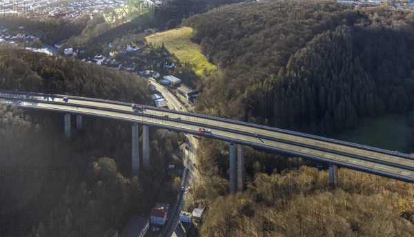 Aerial photograph, construction work with emergency reinforcement on the dilapidated and closed Rahmede viaduct of the A45 Sauerlandlinie motorway over Altenaer Straße in the Gevelndorf district of Lüdenscheid, Sauerland, North Rhine-Westphalia, Germany, A45, construction work, construction measure, construction site, DE, Europe, aerial photograph, aerial photography, aerial photography, Lüdenscheid, emergency reinforcement, through road, Rahmede valley bridge, Sauerland line, closure of the Rahmede valley bridge, traffic jam, traffic jams, overview, traffic chaos, traffic infrastructure, traffic jam, bird's eye view, forest area, birds-eyes view, lack of load-bearing capacity, dilapidated bridge, dilapidated bridges, overview