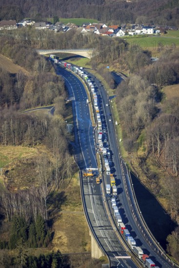 Aerial view, truck traffic jam on the Sterbecke viaduct in front of the closed Rahmede viaduct of the A45 Sauerlandlinie motorway in the Heedfeld district of Schalksmühle, Sauerland, North Rhine-Westphalia, Germany, A45, DE, Europe, truck traffic jam, aerial view, aerial photography, aerial photography, through road, Sauerlandlinie, Schalksmühle, damage to the steel structure, closure of the Rahmede viaduct, traffic jam, traffic jam, overview, traffic volume, traffic chaos, traffic infrastructure, traffic jam, bird's eye view, bird's eye view, lack of load-bearing capacity, closed Rahmede viaduct, dilapidated bridge, dilapidated bridges, overview