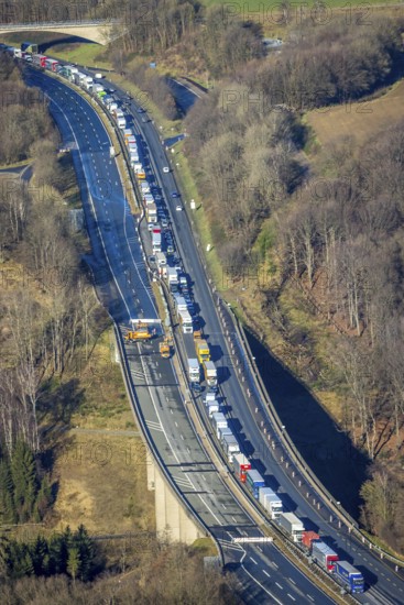 Aerial view, truck traffic jam on the Sterbecke viaduct in front of the closed Rahmede viaduct of the A45 Sauerlandlinie motorway in the Heedfeld district of Schalksmühle, Sauerland, North Rhine-Westphalia, Germany, A45, DE, Europe, truck traffic jam, aerial view, aerial photography, aerial photography, through road, Sauerlandlinie, Schalksmühle, damage to the steel structure, closure of the Rahmede viaduct, traffic jam, traffic jam, overview, traffic volume, traffic chaos, traffic infrastructure, traffic jam, bird's eye view, bird's eye view, lack of load-bearing capacity, closed Rahmede viaduct, dilapidated bridge, dilapidated bridges, overview