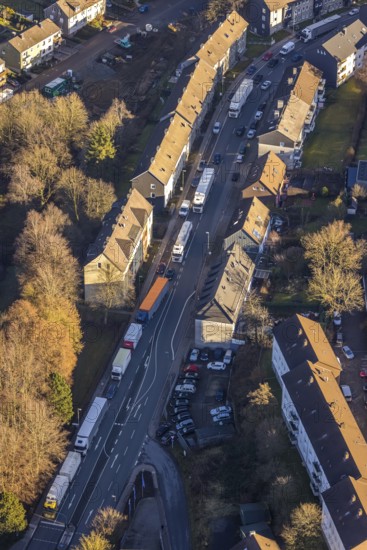 Aerial view, through road with truck traffic jam on the Lennestraße at the exit Lüdenscheid of the motorway A45 Sauerlandlinie because of the closed viaduct Rahmede in the district Leifringhausen in Lüdenscheid, Sauerland, North Rhine-Westphalia, Germany, A45, motorway junction, DE, Europe, truck traffic jam, aerial view, aerial photography, aerial photography, Lüdenscheid, through road, Sauerlandlinie, closure of the Rahmede viaduct, traffic jam, traffic jam, road traffic, overview, diversion, traffic volume, traffic chaos, traffic infrastructure, traffic jam, bird's eye view, birds-eyes view, dilapidated bridge, dilapidated bridges, overview