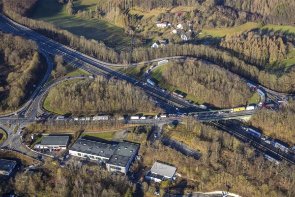 Aerial view, truck traffic jam at the Lüdenscheid exit of the A45 Sauerlandlinie motorway due to the closure of the Rahmede viaduct in the Leifringhausen district of Lüdenscheid, Sauerland, North Rhine-Westphalia, Germany, A45, motorway junction, Brunscheider Straße, DE, Europe, truck traffic jam, aerial view, aerial photography, aerial photography, Lüdenscheid, through road, Sauerlandlinie, closure of the Rahmede viaduct, traffic jam, traffic jam, road traffic, overview, diversion, traffic volume, traffic chaos, traffic infrastructure, traffic jam, bird's eye view, birds-eyes view, closed Rahmede viaduct, dilapidated bridge, dilapidated bridges, overview