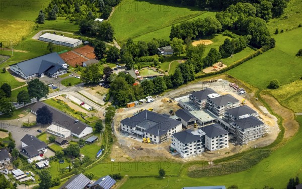 Aerial view, new senior-friendly residential complex WohnGut, spa and community centre, natural adventure pool Lennestadt- Saalhausen, Marien-Grundschule, Saalhausen, Lennestadt, Sauerland, North Rhine-Westphalia, Germany, retirement home, old people's home, construction work, construction area, building site, building plots, construction project, construction site, care and nursing, education, educational institution, DEU, Europe, Fasanenweg, leisure facility, primary school, spa hotel, teaching institute, aerial view, aerial photography, aerial photography, new building, care facility, school, retirement home, retirement residence, retirement home, retirement centre, overview, bird's-eye view, bird's-eye view, overview