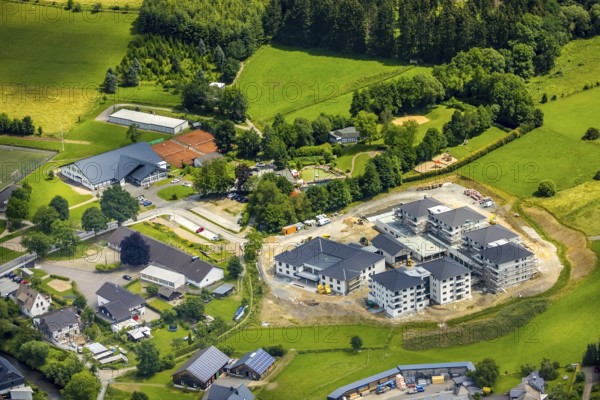 Aerial view, new senior-friendly residential complex WohnGut, spa and community centre, natural adventure pool Lennestadt- Saalhausen, Marien-Grundschule, Saalhausen, Lennestadt, Sauerland, North Rhine-Westphalia, Germany, retirement home, old people's home, construction work, construction area, building site, building plots, construction project, construction site, care and nursing, education, educational institution, DEU, Europe, Fasanenweg, leisure facility, primary school, spa hotel, teaching institute, aerial view, aerial photography, aerial photography, new building, care facility, school, retirement home, retirement residence, retirement home, retirement centre, overview, bird's-eye view, bird's-eye view, overview
