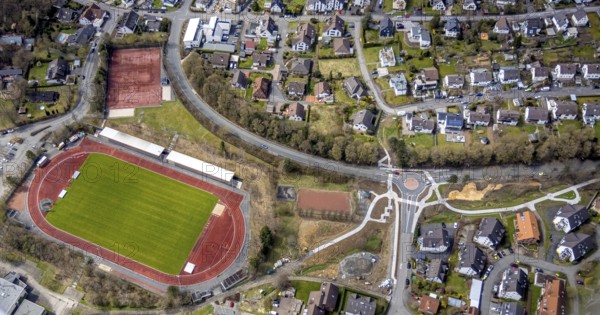 Aerial view, Stählerwiese stadium, roundabout and construction site Hessengarten corner Zum Erbstollen, new construction footpath and cycle path, Kreuztal, Sauerland, North Rhine-Westphalia, Germany, construction work, construction area, construction site, building plots, construction project, construction site, DE, Europe, football pitch, football stadium, Siegen-Wittgenstein district, roundabout, roundabout, athletics stadium, aerial view, aerial photography, aerial photography, sports, sports facilities, sports field, sports facility, overview, bird's-eye view, overview