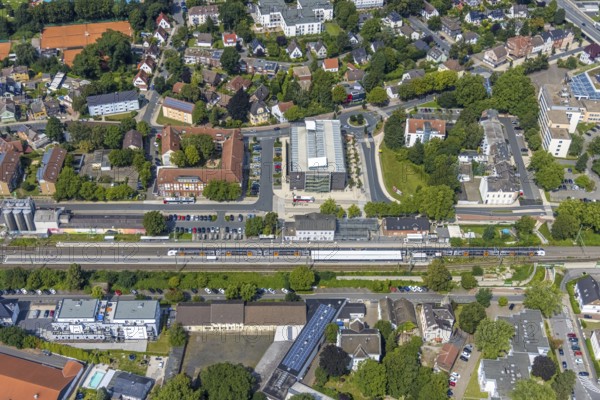 Aerial view, Kamen railway station with multi-storey car park and building of the Unna district police authority, Kamen police station, Kamen, Ruhr area, North Rhine-Westphalia, Germany, eye of the law, railway station, station forecourt, DE, Deutsche Bahn AG, Europe, railway tracks, main railway station, main station, aerial view, aerial photography, aerial photography, law enforcement officer, multi-storey car park, police, police station, police station, state authority, state power, overview, bird's-eye view, bird's-eye view, overview