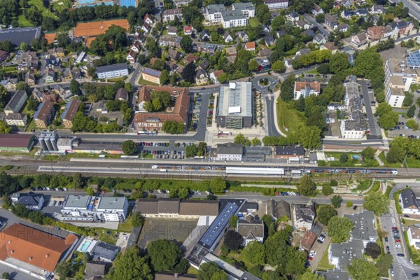 Aerial view, Kamen railway station with multi-storey car park and building of the Unna district police authority, Kamen police station, Kamen, Ruhr area, North Rhine-Westphalia, Germany, eye of the law, railway station, station forecourt, DE, Deutsche Bahn AG, Europe, railway tracks, main railway station, main station, aerial view, aerial photography, aerial photography, law enforcement officer, multi-storey car park, police, police station, police station, state authority, state power, overview, bird's-eye view, bird's-eye view, overview