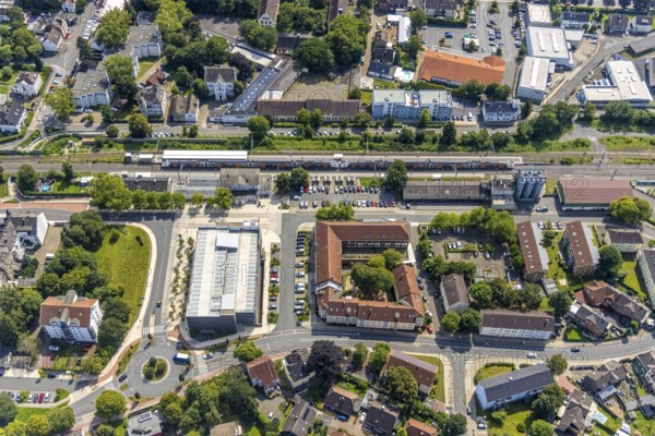 Aerial view, Kamen railway station with multi-storey car park and building of the Unna district police authority, Kamen police station, Kamen, Ruhr area, North Rhine-Westphalia, Germany, eye of the law, railway station, station forecourt, DE, Deutsche Bahn AG, Europe, railway tracks, main railway station, main station, aerial view, aerial photography, aerial photography, law enforcement officer, multi-storey car park, police, police station, police station, state authority, state power, overview, bird's-eye view, bird's-eye view, overview