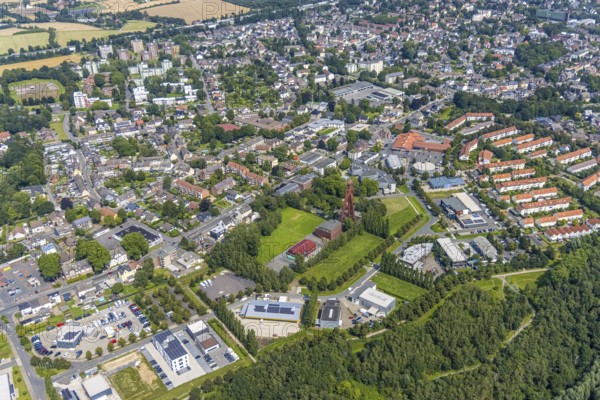 Aerial view, Start-up centre and Technopark Kamen on the former site of the Monopol Schacht Grillo colliery with winding tower Kamen, garden settlement Gertrud-Bäumer-Straße and Helene-Lange-Straße with red roofs in Kamen, Ruhr area, North Rhine-Westphalia, Germany, mining, DE, Europe, winding tower, commercial enterprises, commercial area, commercial location, commercial use, industrial area, industrial location, Kamen, aerial view, aerial photography, aerial photography, sight, coal mine, technology park, tower, overview, bird's-eye view, former mine, overview