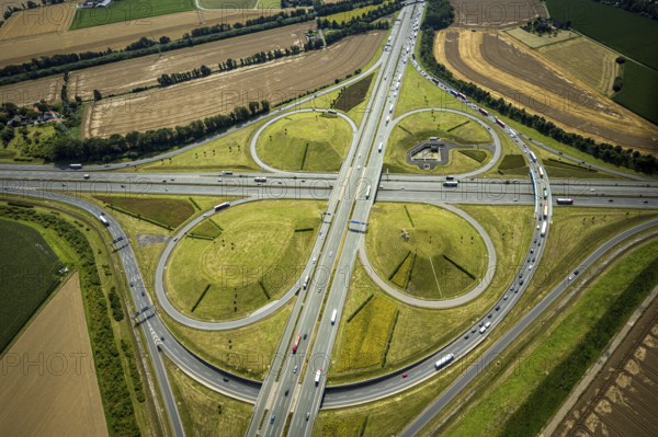 Aerial view, Kamen interchange with A1 motorway and A2 motorway, helicopter sculpture Yellow Angel in inner circle, Kamen, Ruhr area, North Rhine-Westphalia, Germany, motorway, Kamen interchange, DE, Europe, shapes and colours, clover shape, aerial view, aerial photography, aerial photography, sculpture, road traffic, overview, traffic volume, bird's eye view, birds-eyes view, overview