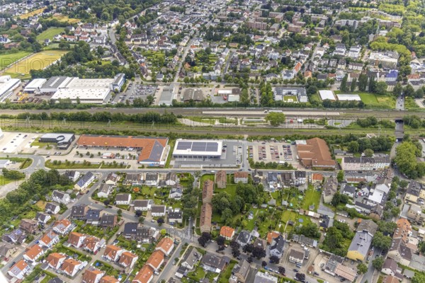 Aerial view, Holzwickede railway station, local supply centre, new Aldi supermarket, Freiberg, Holzwickede, Ruhr area, North Rhine-Westphalia, Germany, new Aldi supermarket, railway tracks, railway station, DE, Deutsche Bahn AG, shopping markets, shopping square, shopping centre, Europe, main station, main railway station, aerial view, aerial photography, aerial photography, photovoltaics, photovoltaic system, solar, solar system, solar roof, solar energy, solar energy, supermarket, overview, bird's eye view, birds-eyes view, overview
