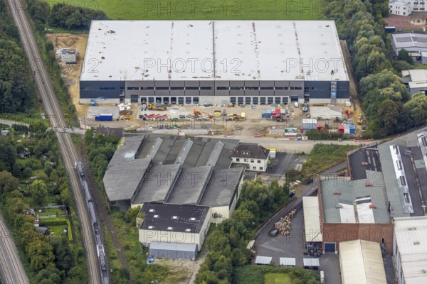 Aerial view, construction site and new construction of a logistics centre of Hillwood HWE GmbH at Schäferkampstraße in the district Hohenleuchte in Holzwickede, Ruhr area, North Rhine-Westphalia, Germany, construction work, construction area, building site, building plots, construction project, construction site, DE, Europe, Holzwickede, logistics, logistics service, logistics service provider, logistics provider, logistics centre, aerial view, aerial photography, aerial photography, new construction, transport service, overview, bird's-eye view, birds-eyes view, overview