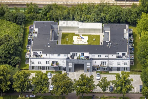 Aerial view, Am Bahnhof Holzwickede, new residential and commercial building in Bahnhofstraße with indoor playground, Freiberg, Holzwickede, Ruhr area, North Rhine-Westphalia, Germany, DE, Europe, commercial enterprises, commercial space, commercial location, commercial use, property tax, real estate, aerial view, aerial photography, aerial photography, overview, bird's-eye view, residential complex, living and life, residential buildings, quality of life, birds-eyes view, overview