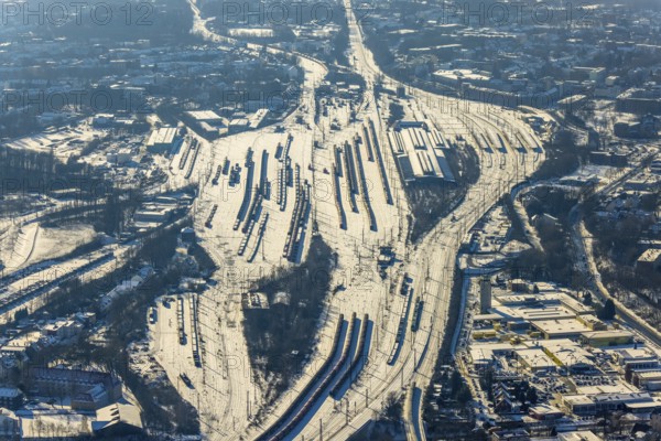 Aerial view, Wanne-Eickel main station, signal box, railway tracks in the snow, Baukau-West, Herne, Ruhr area, North Rhine-Westphalia, Germany, railway tracks, station, DE, Deutsche Bahn AG, Europe, railway tracks, goods trains, main station, central station, aerial view, aerial photography, aerial photography, snow, overview, bird's eye view, winter, birds-eyes view, overview