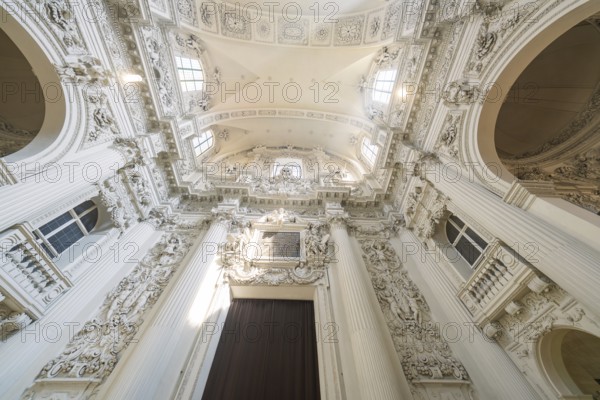 View of the richly decorated ceiling of a baroque church with architectural details, Munich, Germany